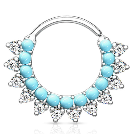 A platinum turquoise septum ring featuring multiple turquoise stones and cubic zirconia lined around the bottom of the bendable hoop pictured against a white background.