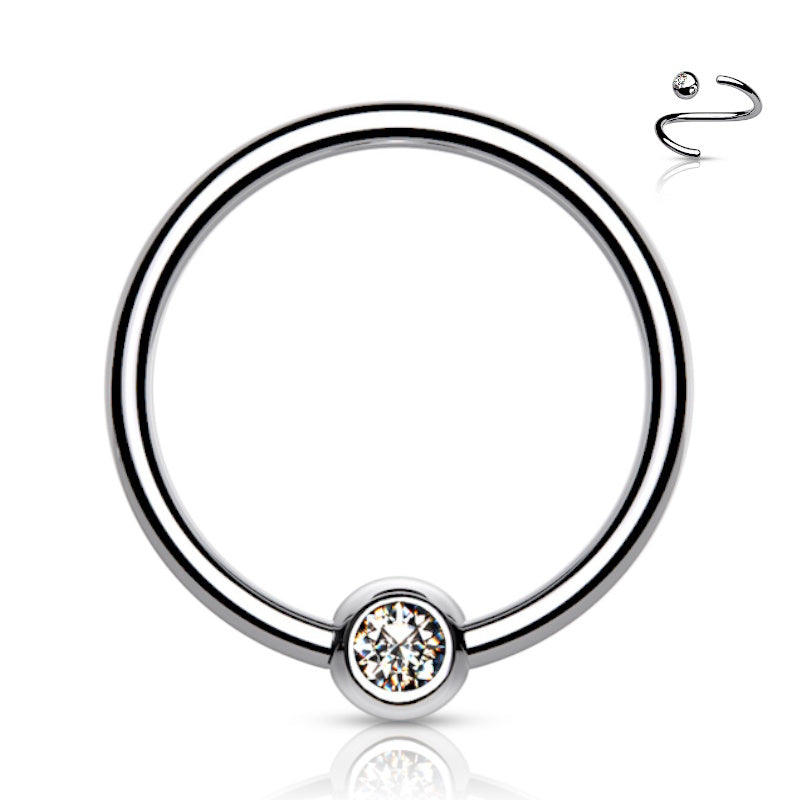 A 14 gauge septum ring featuring a bezel set cubic zirconia ball pictured against a white background.