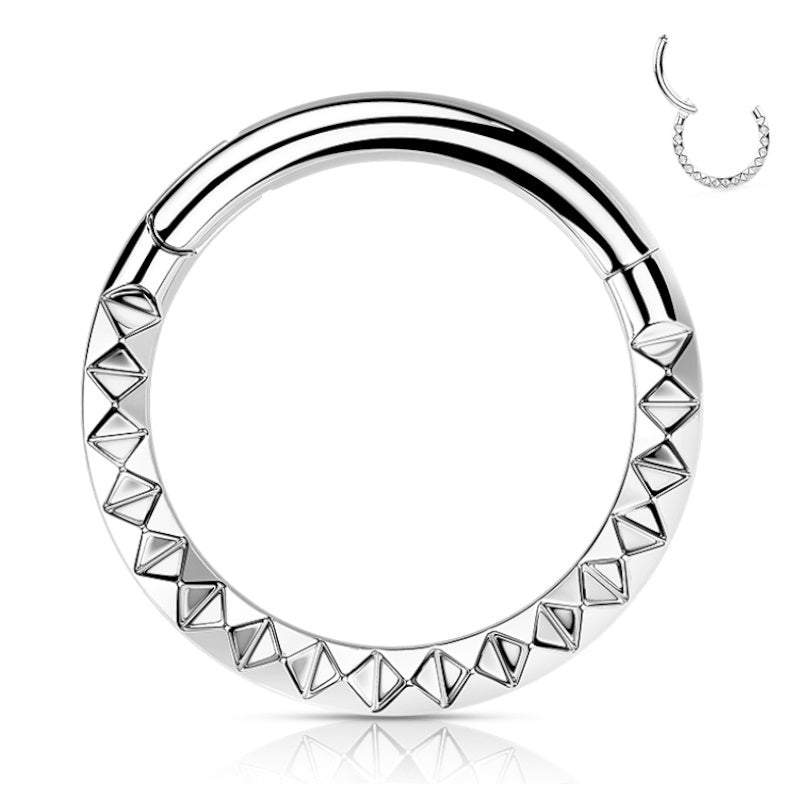 A 16 gauge septum ring crafted from titanium with a pyramid cut studded front and a hinged closure pictured against a white background.