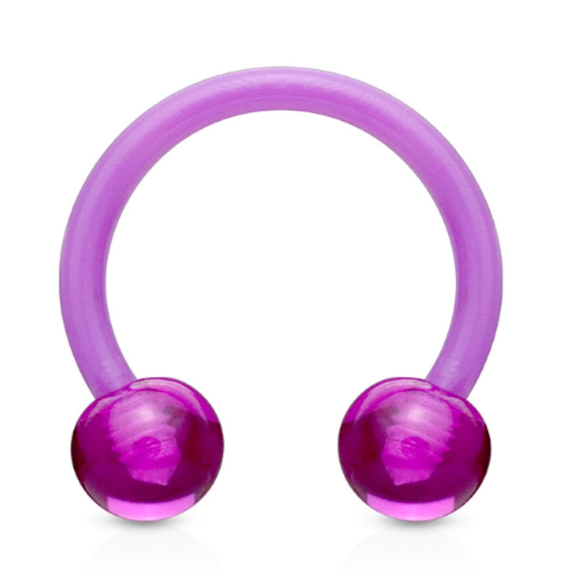 An acrylic purple septum ring featuring a horseshoe shape with a ball on each end pictured against a white background.