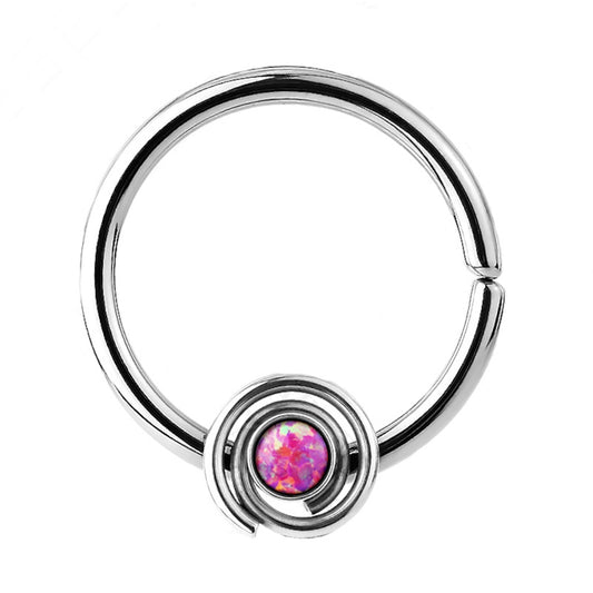 A bendable opal septum ring with a synthetic pink opal pictured against a white background.