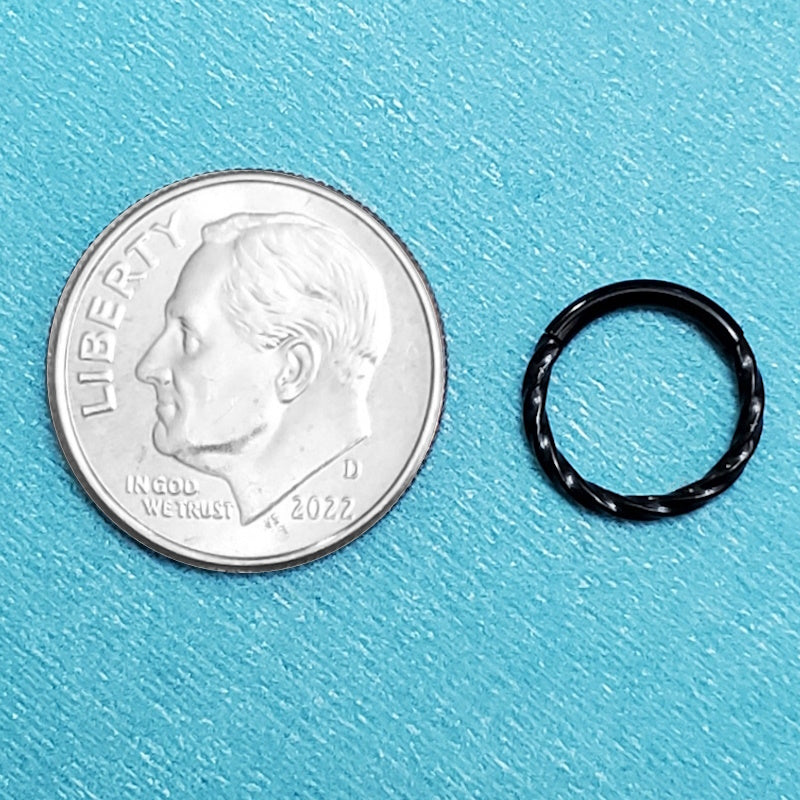 A black septum nose ring pictured on an aqua background next to a dime for a size comparison.