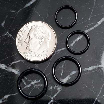Black Hinged Segment Septum Hoop ASTM F136 Titanium 20G 18G 16G 14G pictured on a black marble countertop next to a dime for size comparison.
