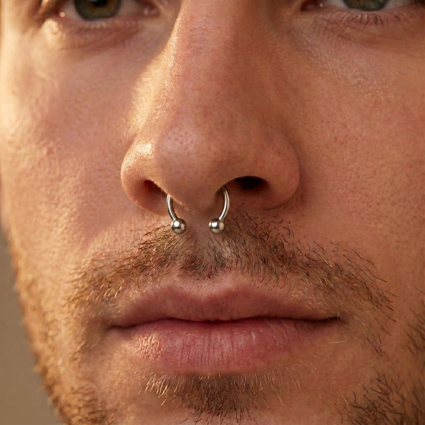 Circular Barbell Septum Ring 316L Surgical Steel Internally Threaded pictured in the septum piercing of a male model.