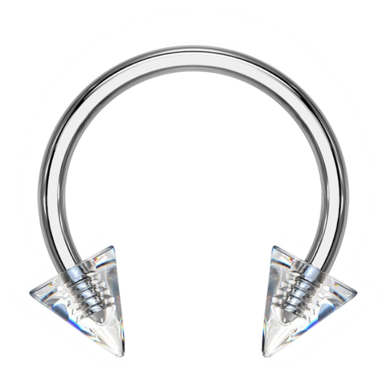 A 16 gauge clear spike septum ring featuring a horseshoe ring with a clear spike on each end of it pictured against a white background.