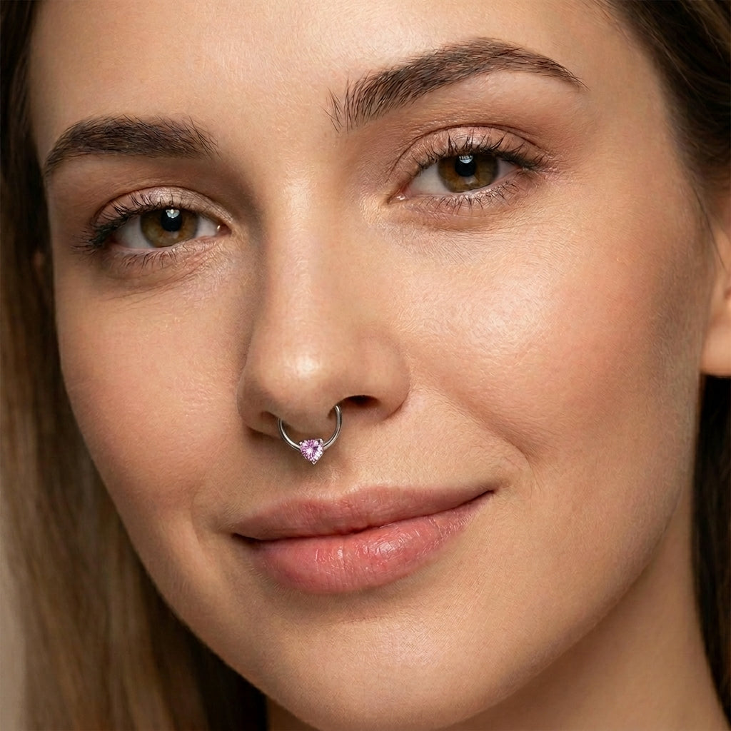 Heart CZ Captive Bead Septum Ring 16 Gauge 316L Surgical Steel  with pink CZ pictured in the septum piercing of a female model.