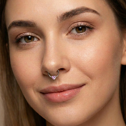 Heart CZ Captive Bead Septum Ring 16 Gauge 316L Surgical Steel  with pink CZ pictured in the septum piercing of a female model.