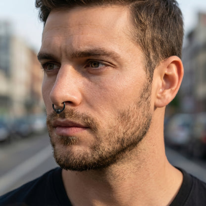 Black Captive Bead Septum Ring 316L Surgical Steel Matte Black pictured in the septum piercing of a male model.
