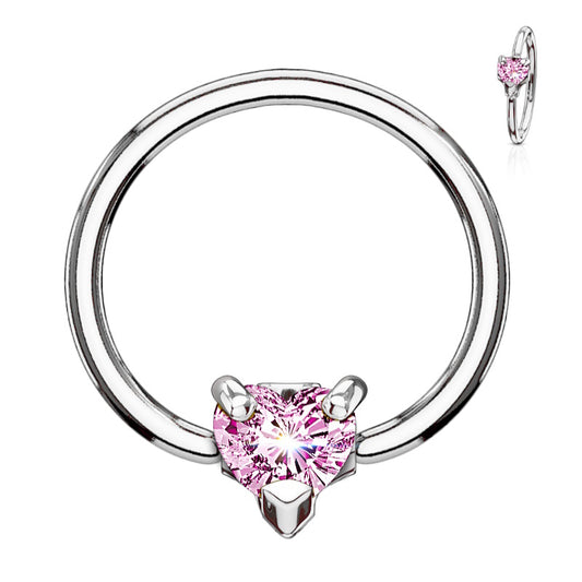 A pink heart septum ring featuring a captive bead pink Cubic Zirconia heart pictured against a white background.