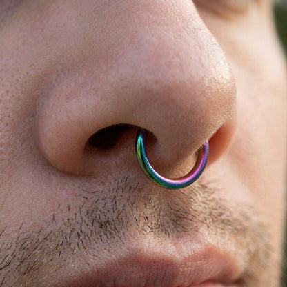 Rainbow Hinged Segment Ring 316L Surgical Steel pictured in the septum piercing of a male model.