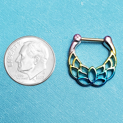 A rainbow lotus septum ring pictured on an aqua background next to a dime for a size comparison.