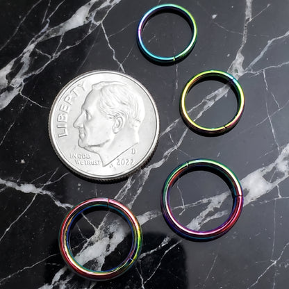 Rainbow Hinged Segment Septum Hoop ASTM F136 Titanium 20G 18G 16G 14G pictured on a black marble countertop to show size comparison to a dime.