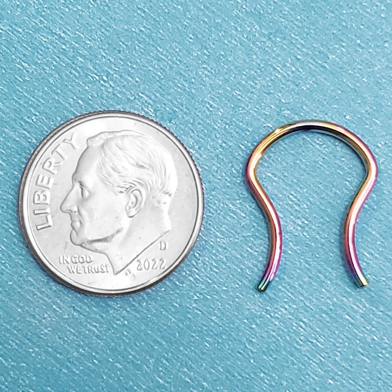 A rainbow titanium septum retainer pictured on an aqua background next to a dime for a size comparison.