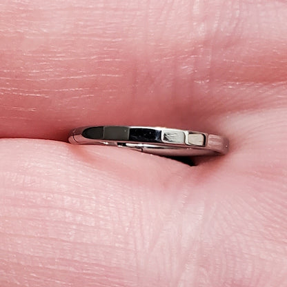 Rectangular Facet Segment Septum Hoop 16 Gauge ASTM F136 Titanium pictured between to fingers to see the rectangular facets.