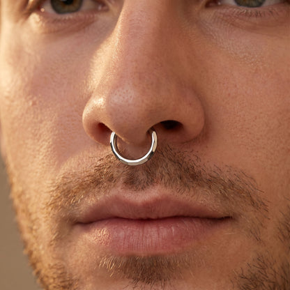 Rectangular Facet Segment Septum Hoop 16 Gauge ASTM F136 Titanium pictured in the septum piercing of a male model.