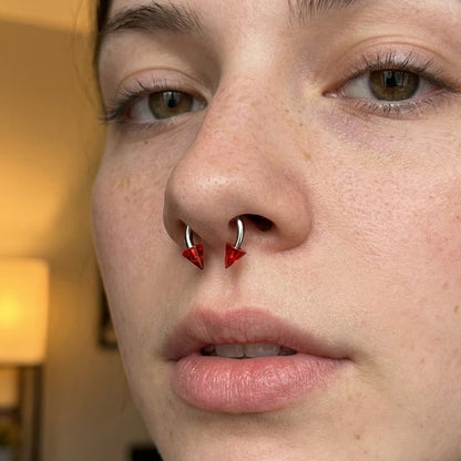 Spike Septum Ring 16 Gauge 316L Surgical Steel & Acrylic Red in the septum piercing of a female model.