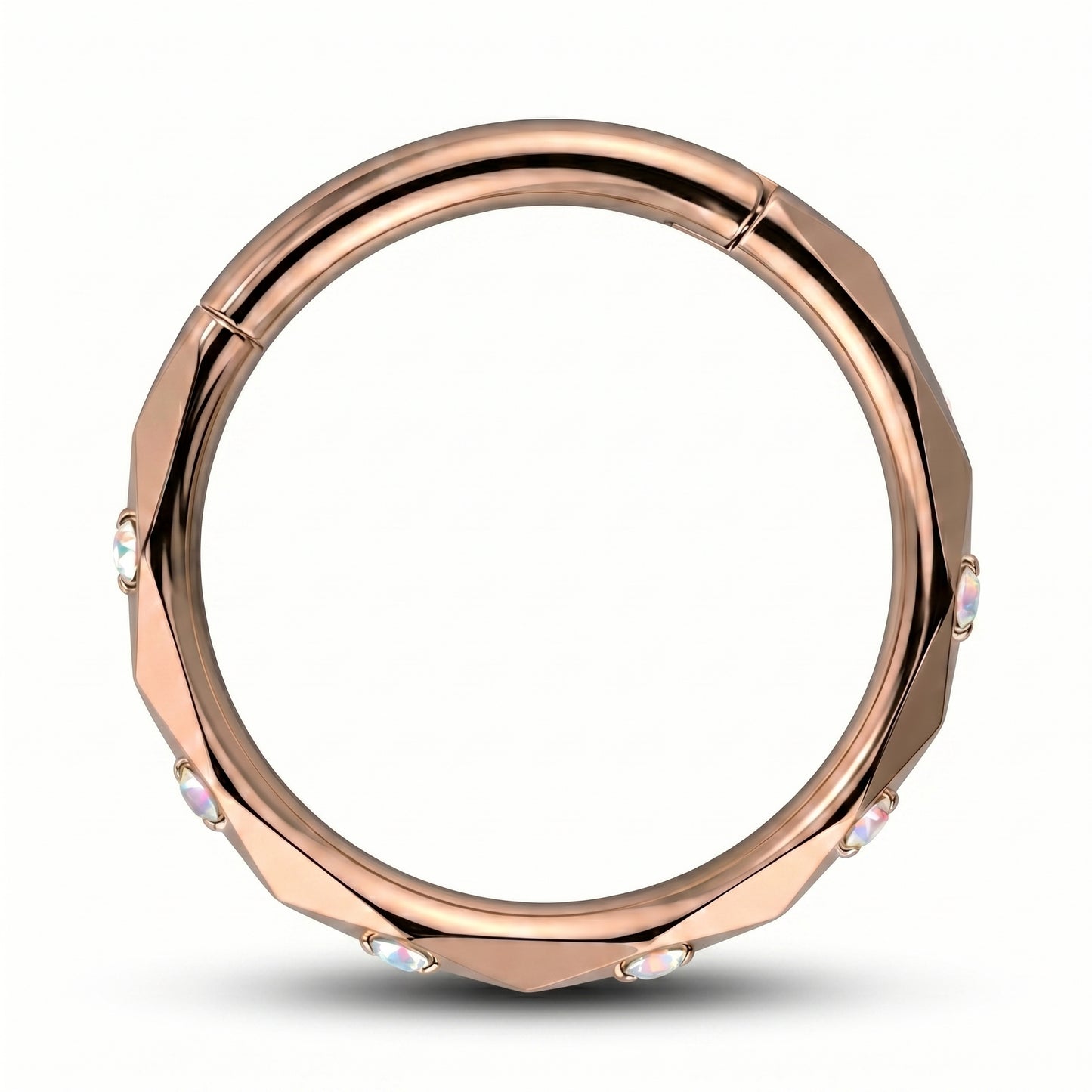 A Rose Gold Cubic Zirconia Segment Ring accented with diamond faceted cuts pictured against a white background.
