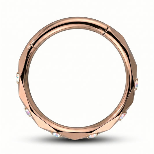A Rose Gold Cubic Zirconia Segment Ring accented with diamond faceted cuts pictured against a white background.