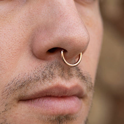 Rose Gold Hinged Segment Hoop ASTM F136 Titanium pictured in the septum piercing of a male model.