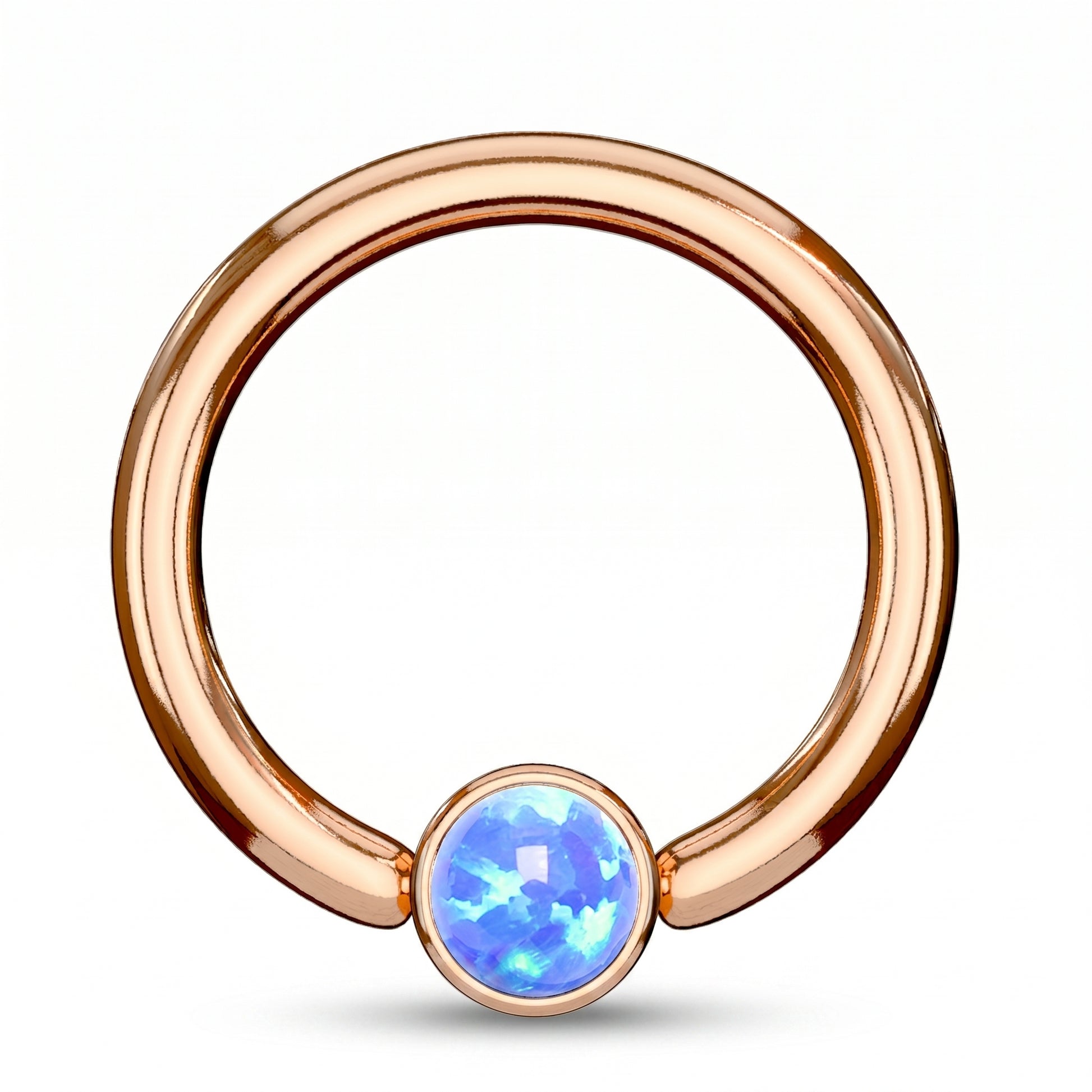 A rose gold opal captive bead septum ring featuring a synthetic blue opal on a rose gold hoop pictured against a white background.