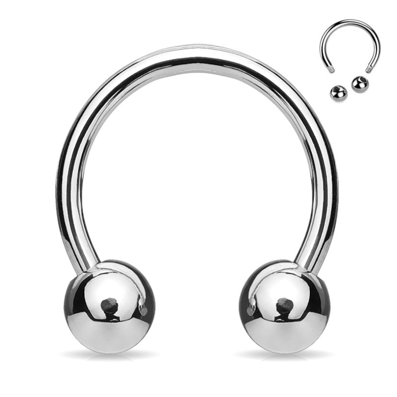 An externally threaded stainless steel septum ring that is horseshoe shaped with a ball on each end pictured against a white background.