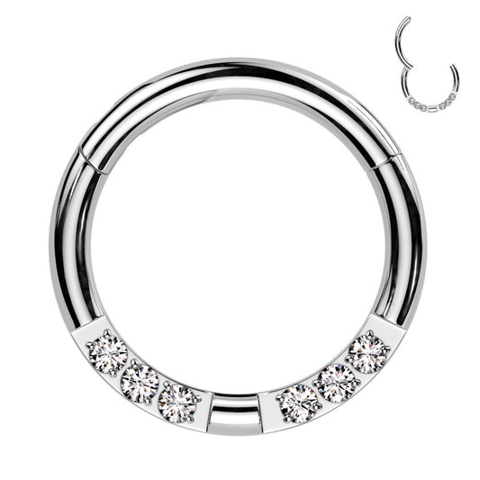 A surgical steel 16g segment ring with 6 cubic zirconia pictured against a white background.