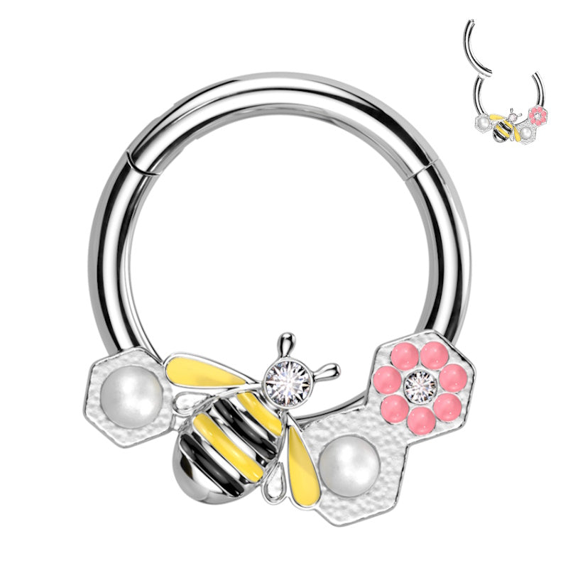 A surgical steel bee septum ring with a bumble bee and pink flower on a clicker style hoop pictured against a white background.