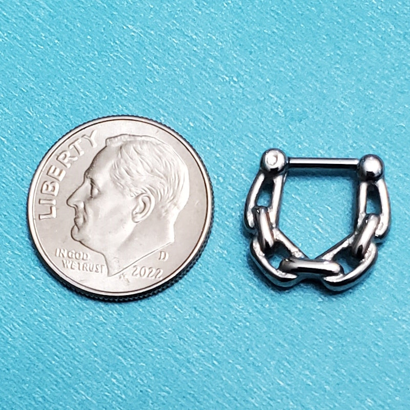 A surgical steel chain septum clicker pictured on an aqua background next to a dime for a size comparison.