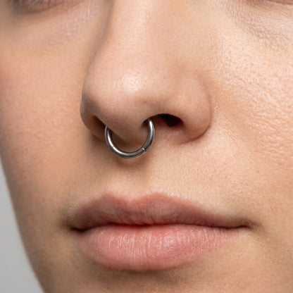 Hinged Segment Septum Ring 316L Surgical Steel pictured in the septum piercing of a female model.