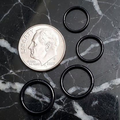 Black Hinged Segment Septum Ring 316L Surgical Steel 20G 18G 16G 14G pictured next to a US dime on a black marble countertop for a size comparison.