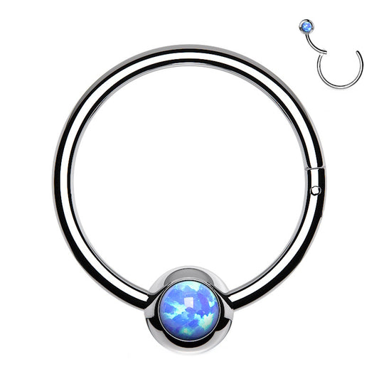 A surgical steel opal septum ring featuring an opal in the ball that's attached to a hinged segment of a hoop pictured against a white background.