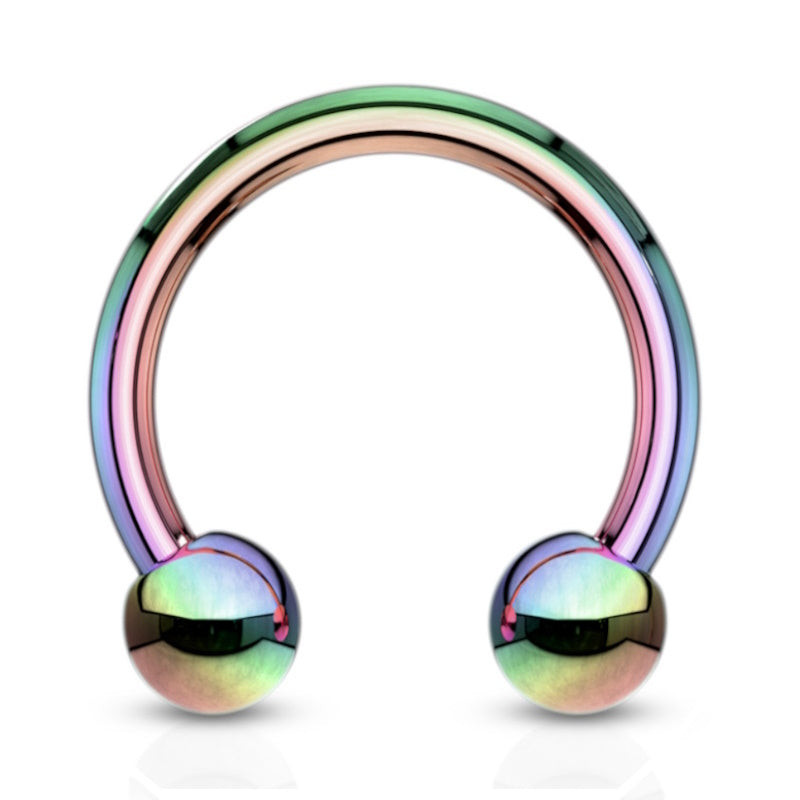 A surgical steel rainbow septum ring in a horseshoe shape with a ball on each end pictured against a white background.