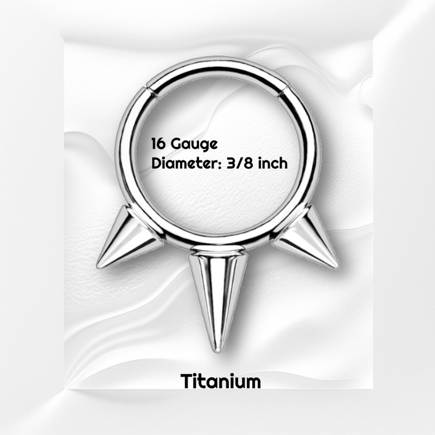 Three Spike Segment Septum Ring 16 Gauge ASTM F136 Titanium pictured against a gray wavy background with black text stating the size and material.