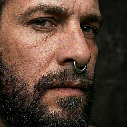 Hinged Segment Ring 8 Gauge ASTM F136 Titanium Silver in the septum piercing of a male model.