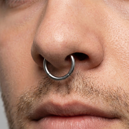 Hinged Segment Septum Ring ASTM F136 Titanium pictured in the septum piercing of a male model.