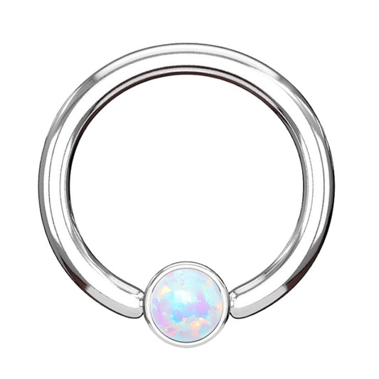 A white opal septum ring featuring a surgical steel hoop with a cylinder shape opal bead pictured against a white background.